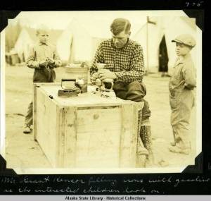 189. Mr_Grant_Kensor_Kenser_filling_irons_with_gasoline_as_the_interested_children_1ook_on